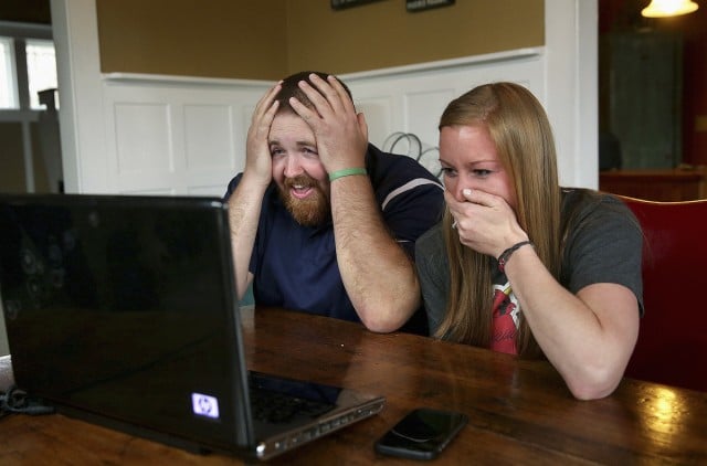 Joel Burger and Ashley King react at King’s home in New Berlin, Ill., after learning from a New York public relations firm that Burger King has offered to pay the expenses and provide gifts for their wedding because of their interesting connection to the fast food restaurant chain. (AP)