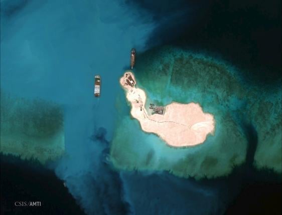 Satellite image of cargo being unloaded onto the shore of the Mischief Reef