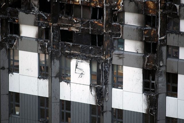 The remains of cladding on the outside of Grenfell Tower, London. At least 58 people are now missing and presumed dead in the Grenfell Tower disaster, police have said. Photo EPA/Will Oliver