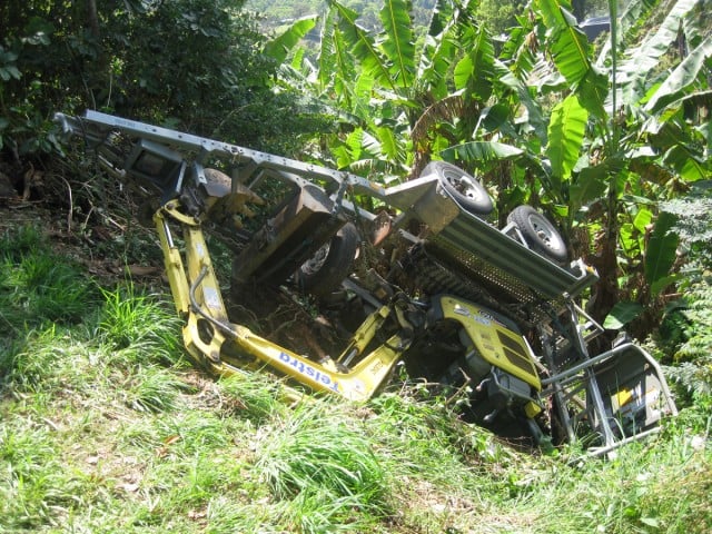 A mini excavator on a trailer lies in a gully on Wilsons Creek Road at Laverty's Gap. Photo Luis Feliu 