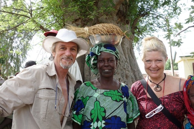 Seeds of Wisdom Michel Fanton (left) and Jude Fanton (right) under a baobab tree with rice farmer showing her ancient swamp rice, Sankuya village, The Gambia, during their Seed Solidarity Tour, July 2013. Photo a passerby on the Fantons camera.