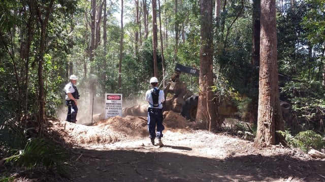 Police stand guard as loggers continue to haul logs out of a private property at Whian Whian in 2013.The state government has rejected an application from Ballina council to introduce a planning instrument to control native forestry in the shire. 