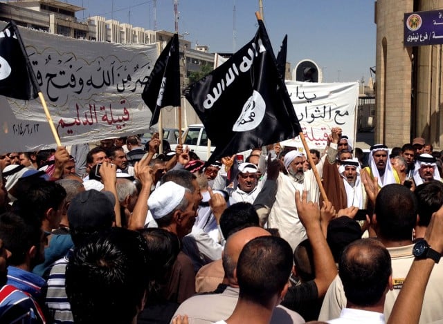 Demonstrators chant pro-al-Qaida-inspired Islamic State of Iraq and the Levant slogans as they wave al-Qaida flags in front of the provincial government headquarters in Mosul, Iraq, on Monday (June 16, 2014). Photo AP