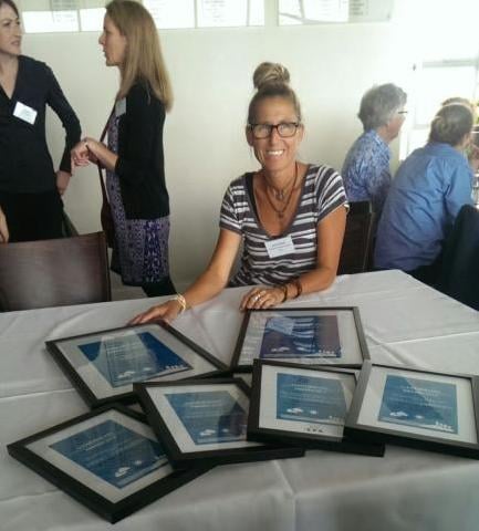 Annie Pollard from Cabarita Dune Care with a swag of KAB awards in Sydney. 