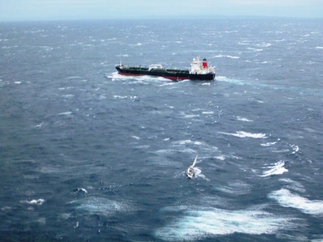 The British Loyalty steams away from the rescue site, leaving the stricken yacht Red Sky foundering in heavy seas. Photo Life Saver Rescue Helicopter