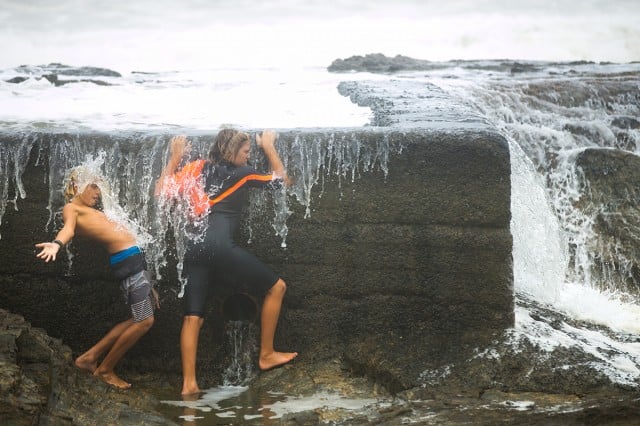 Getting barrelled on (not so) dry land. Adventurous kids found a way to ride out Cyclone Marcia at Snapper rocks on Sunday.