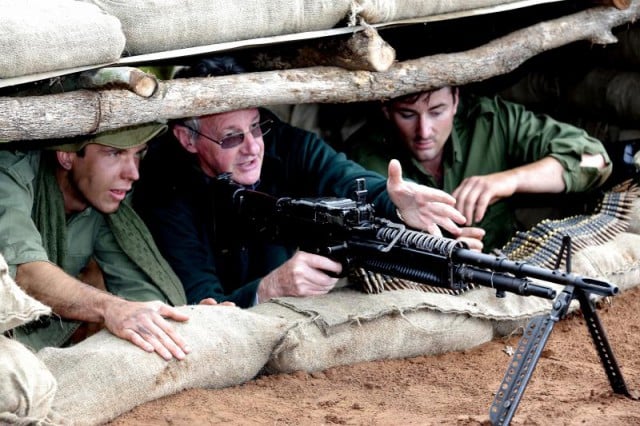 Vietnam veteran Paul Donnelly instructs actors in The Crater on firing a machine gun. 