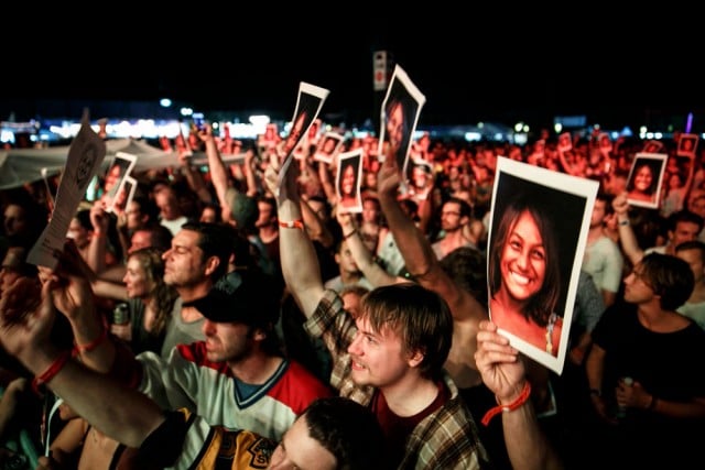 Dispatch fans hold up photos of Ileana, the face of band member Brad 'Braddigan' Corrigan's charity 'Love, Light and Melody. Photo Tree Faerie.