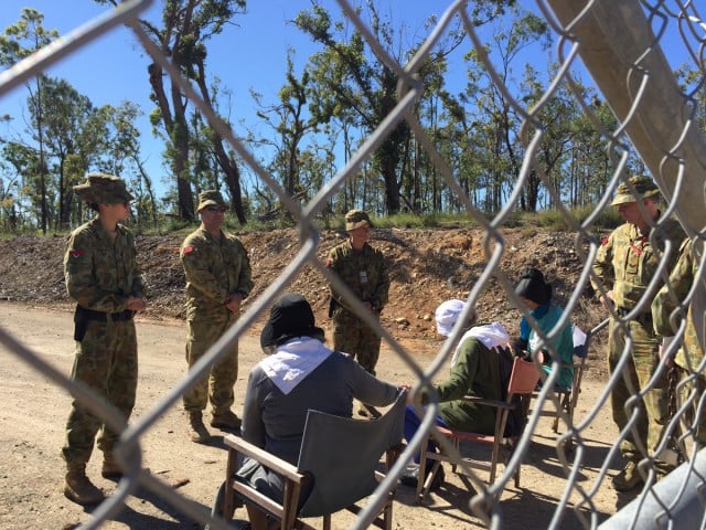 Australian soldiers surround the three grandmothers before their arrest. Photo supplied