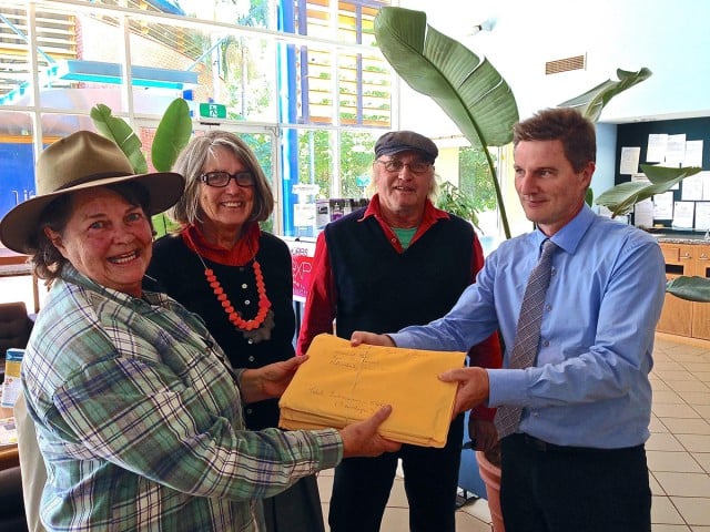 Byron Farmers’ Market treasurer Kaye Shadbolt, along with local producers Liz and Bob Gray, handed 540 submissions to Council staffer Phil Holloway on Friday. Photo contributed.