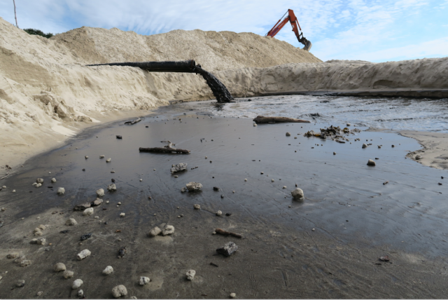 Spoil from dredging in the  Evans River is pumped into holding ponds. (supplied)