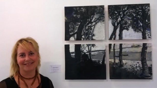 Nadia Cardak with one of several four-panel encaustic paintings which were on show.