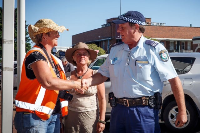 Jo Holden greets Senior Constable Peter Hartley outside the Santos office in Narrabri. Photo Tree Faerie.