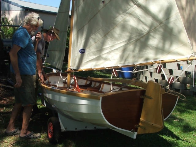 Barry Kean and Paul Webb at work on their wooden boat. (supplied)