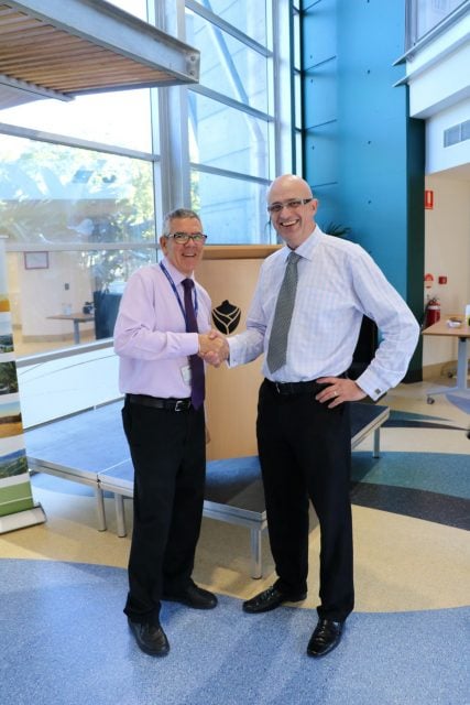 Southern Cross University's executive director, information and physical resources, Allan Morris, congratulates Tweed Shire Council general manager Troy Green on the official opening of Council's Tweed Heads Administration building yesterday. The building was formerly owned by SCU. Photo Tweed Shire Council