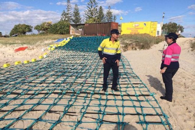Edward Khoury,  director of the company behind the shark nets (Global Marine Enclosures) with inspects part of the failed barrier at Lennox Head. Photo: ABC North Coast/Bruce MacKenzie 
