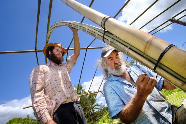 Rob Swain and Craig Roper, who are securing the bamboo to become a strucutre.  Photo Jeff Dawson