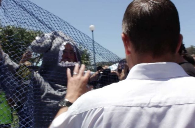 Marine activist Dean Jefferys attempts to throw a net over premier Mike Baird. (supplied)