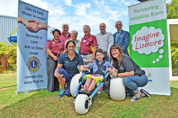 : Launching the new beach wheelchair are (front) Ashton, his mum Angela Mathew of Lifestyle Solutions and Elisha Hillier from Goonellabah Sports & Aquatic Centre with (rear l-r) Lismore City Lions Club members Nancy Casson, Rod Johnston, Lola Reichelt and Sandy McLean, DAISI Executive Officer Brett Carn and Lismore’s Deputy Mayor Gianpiero Battista. (supplied)