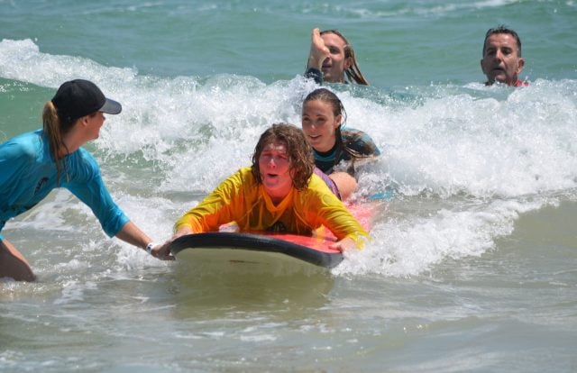 Volunteer-assisted surf action at Clarkes Beach. Photo Diana Willis