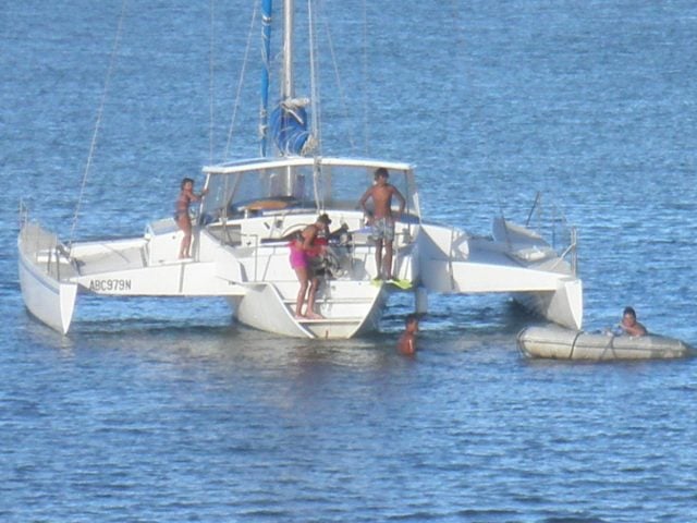 A photo supplied by police showing a family on the damaged vessel.