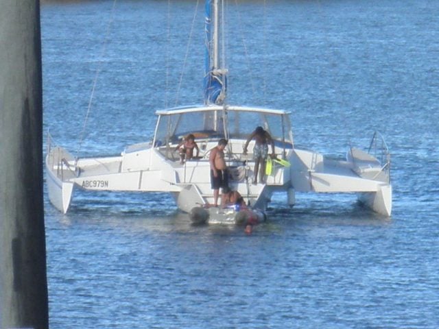 A photo supplied by police showing a family on the damaged vessel.