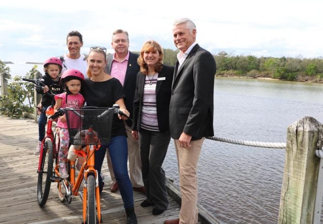 Casuarina residents Oscar and Alison Fincarik and their children Savannah, 4 and Torah, 3, welcomed funding for the new boardwalk. They're pictured on a section to be rebuilt with planning minister Anthony Roberts, Tweed mayor Katie Milne and Teed MP Geoff Provest. Photo supplied 