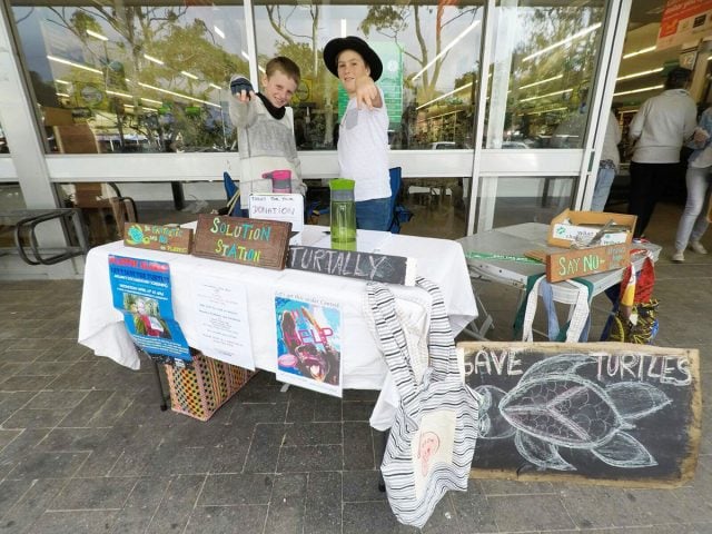 Plastic free boy Arlian and his friend Koah outside Byron Woolworths on Sunday. They were raising awareness of the dangers of plastic on the ocean. Photo supplied.