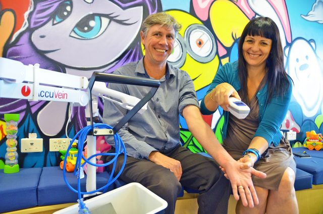 Anthony Magarry from Lismore City Council, a member of the Local Government Charity Golf Day organising committee, and Our Kids fundraising coordinator Rebekka Battista with the new AccuVein AV400, which helps medical professionals find veins easier and administer needles to children more efficiently. Photo supplied. 